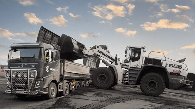 A truck and an excavator in the picture